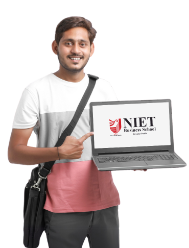 Male student smiling and pointing at a laptop displaying the NIET Business School Greater Noida